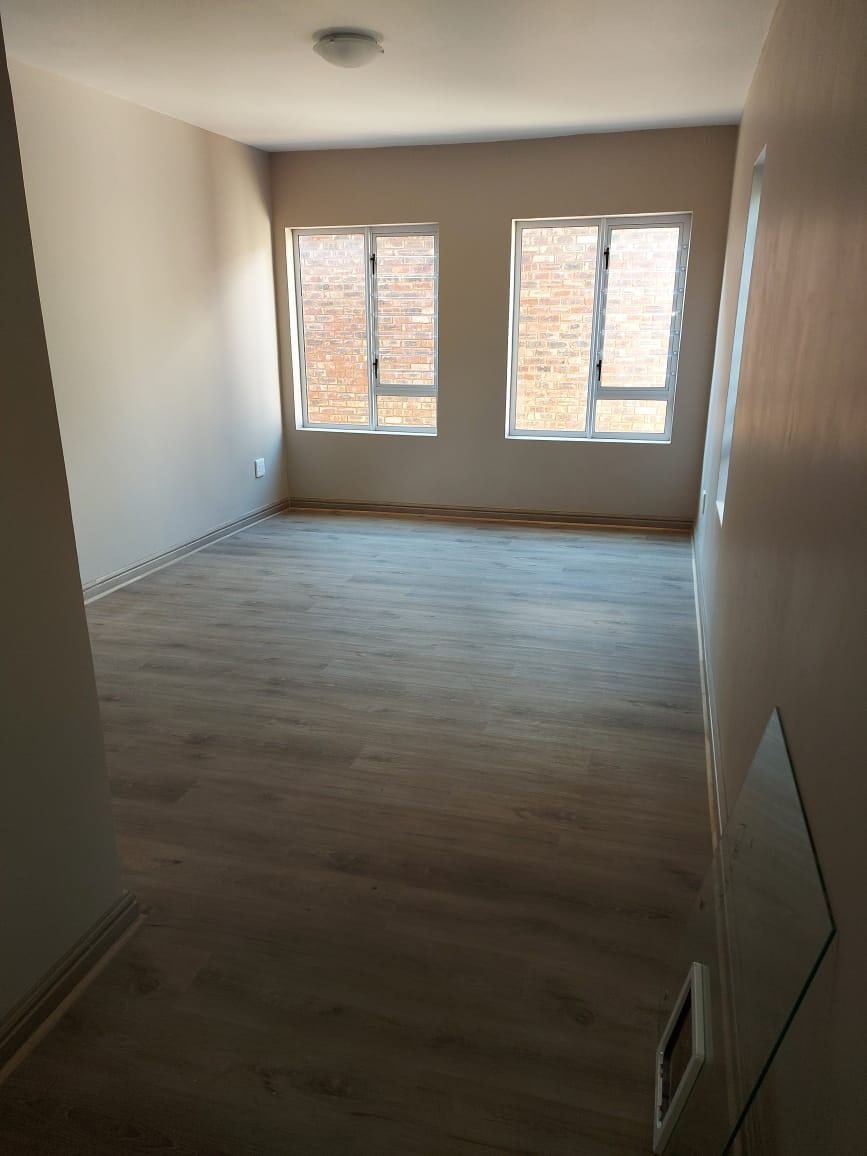 Grey SPC flooring in an empty bedroom