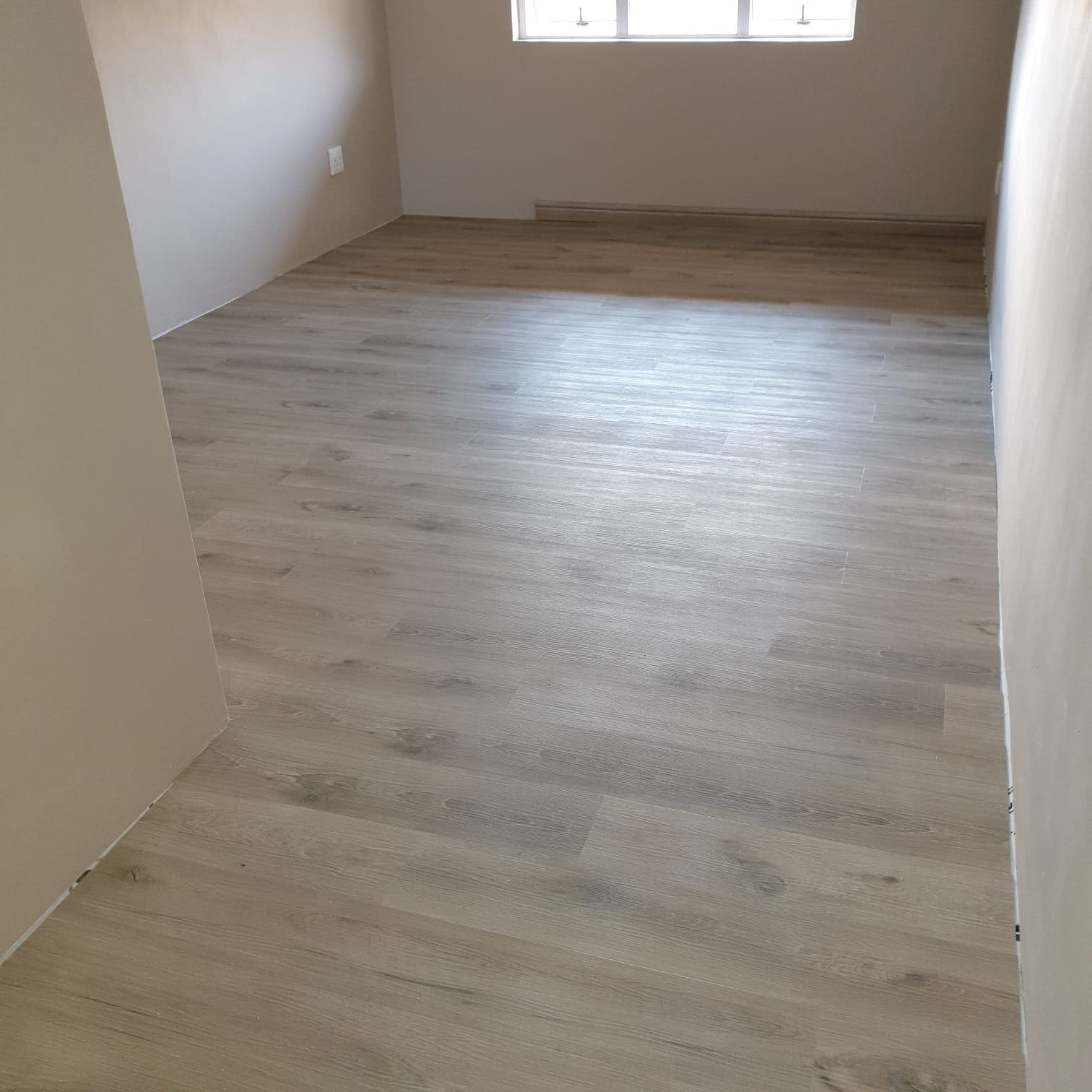 Grey SPC flooring in a newly finished room