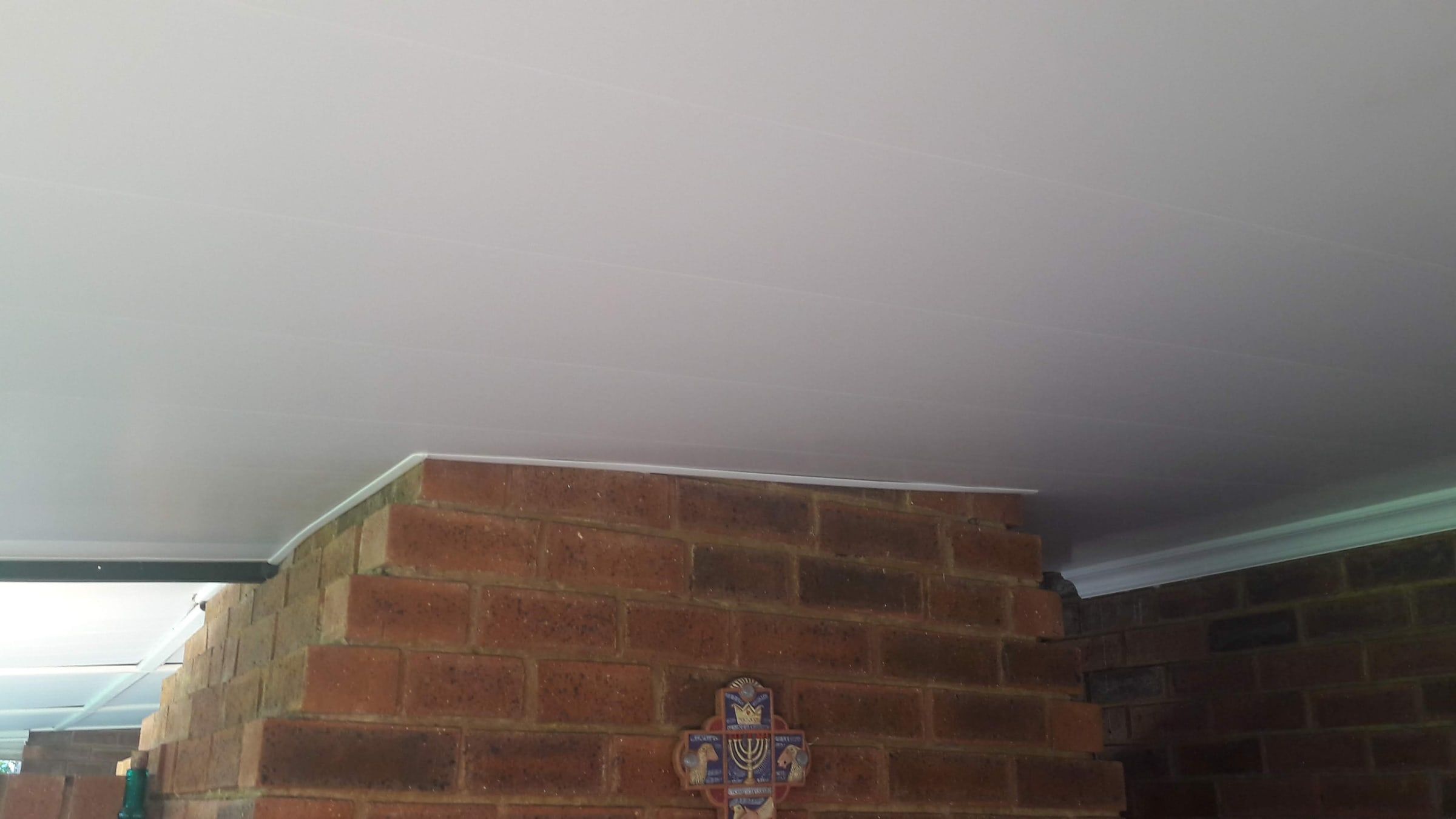 PVC ceiling finished neatly around a face-brick chimney