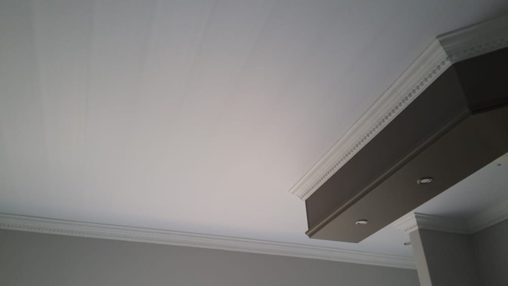 PVC ceiling and cornice with a dark bulkhead and downlights