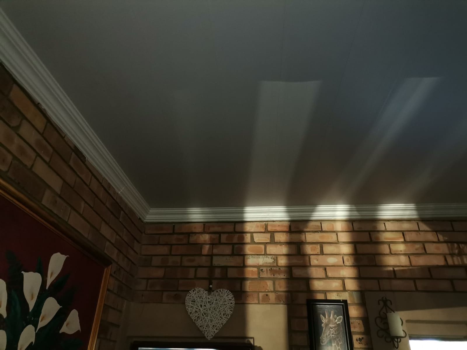 PVC ceiling and cornice in a face-brick room