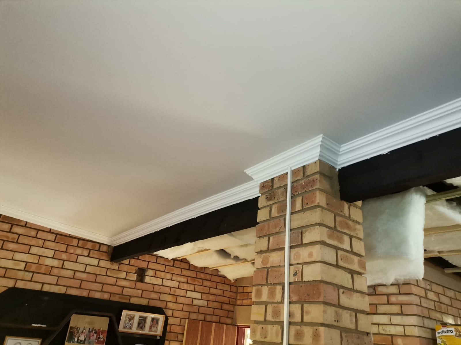 PVC ceiling being installed with insulation above the panels