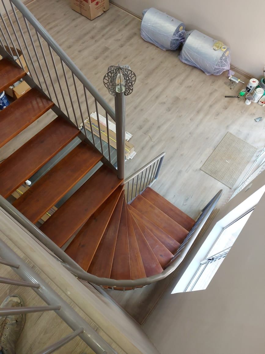 SPC flooring being installed on a loft landing beside a staircase