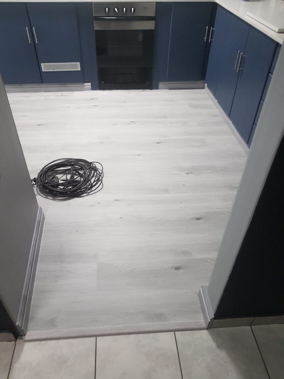 SPC flooring running through a galley kitchen
