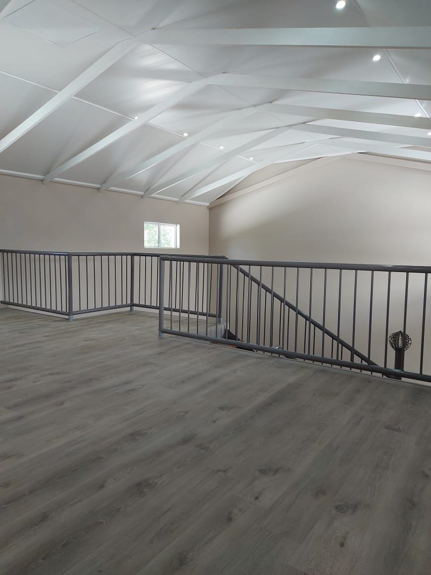 Grey SPC flooring on a loft landing